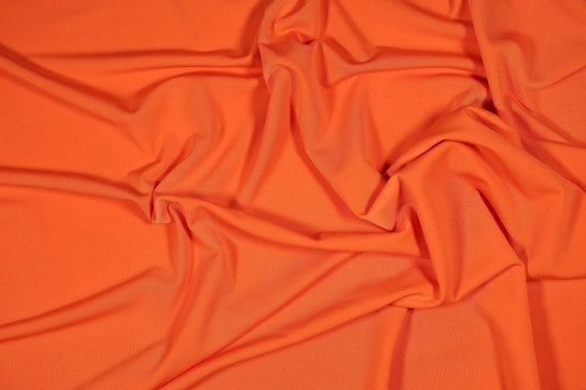 Energiegeladener oranger Stretch-Stoff fĂŒr Sportmode und auffĂ€llige Kleider