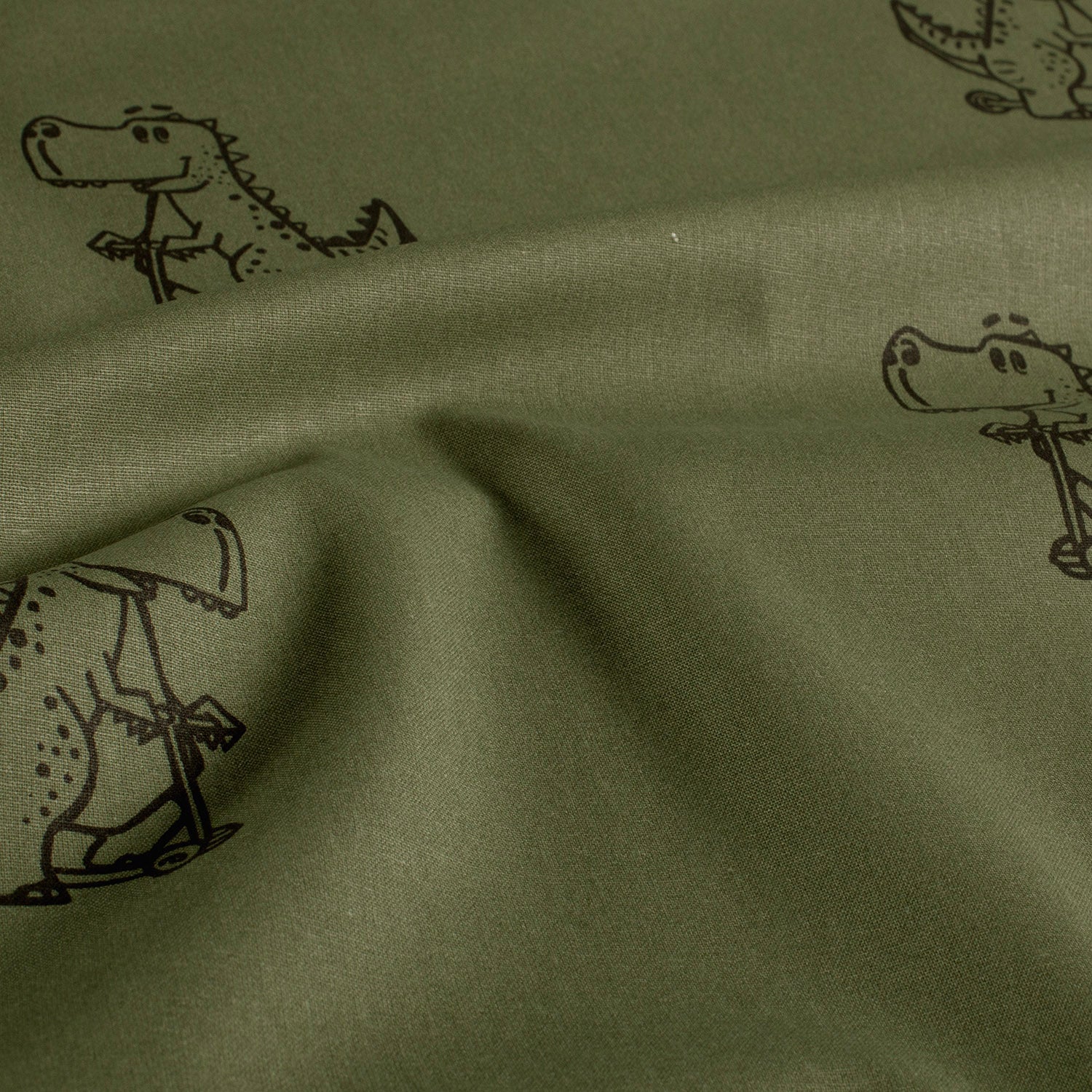 Baumwoll-Popeline Dinosaurier Dunkelgrün – Stoffansicht